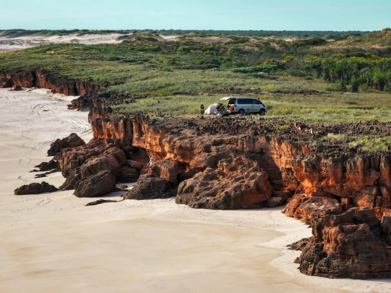 campervan parked at a remote bush campsite in the australian outback at dusk