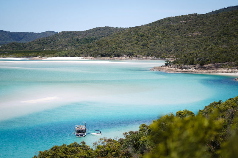 aerial view of white sand swirling through turquoise shallow water
