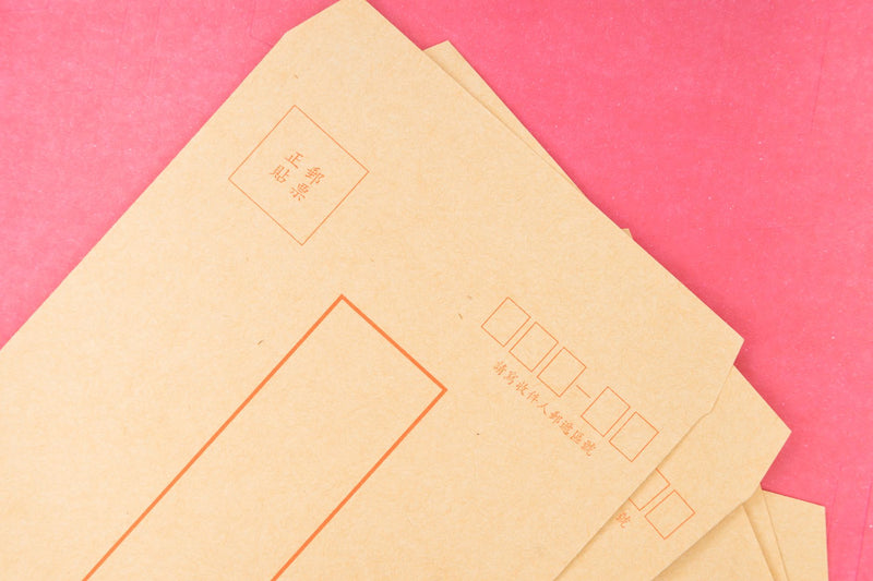 pile of unopened white envelopes lying on doormat near front door