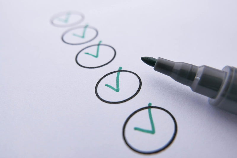 Checklist with green ticks marked with a marker pen