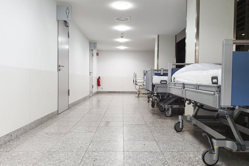 Empty modern Australian hospital corridor with rolling beds and sterile environment