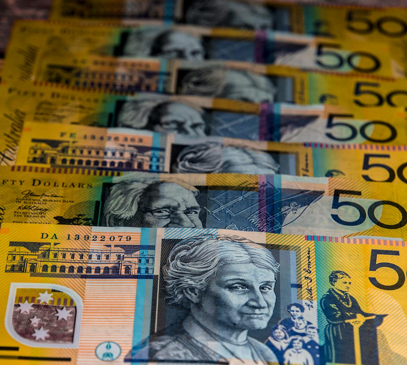 Australian fifty dollar notes fanned out on a surface