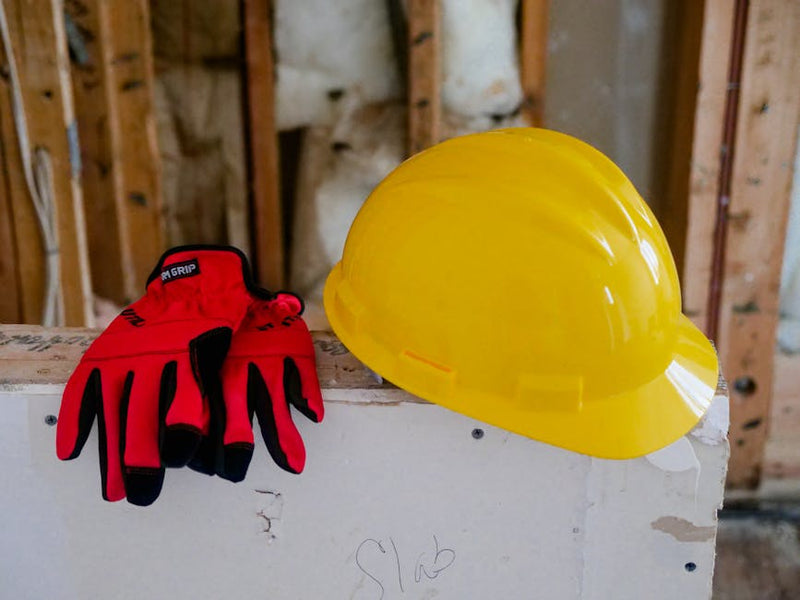 work safety boots gloves hard hat receipts on table